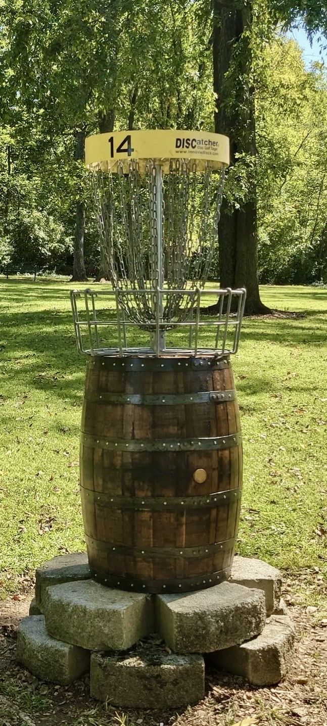 East Frankfort Park hole 14 DISCatcher mounted on a whiskey barrel, yellow band 14